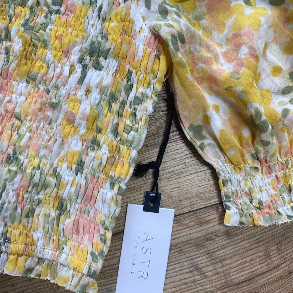 Astr the label yellow floral smocked crop top with puff sleeves.